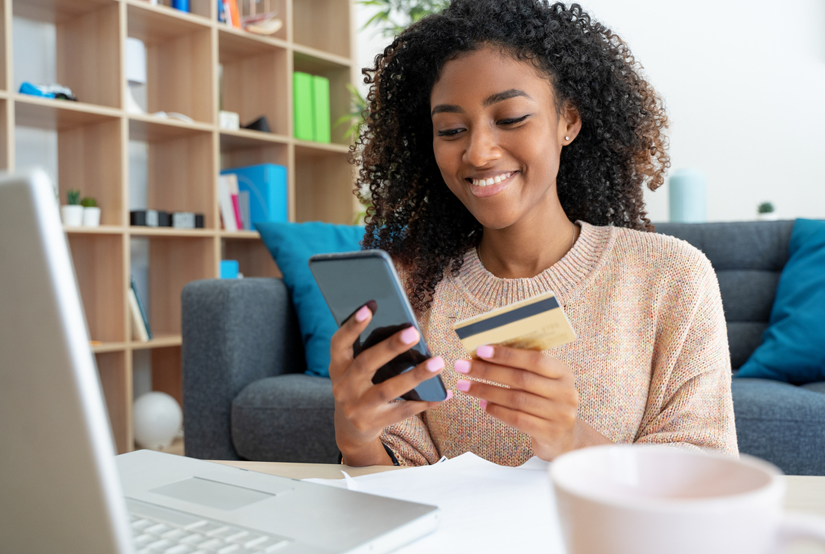 Young woman making a mobile phone payment