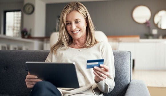 Woman on laptop with credit card