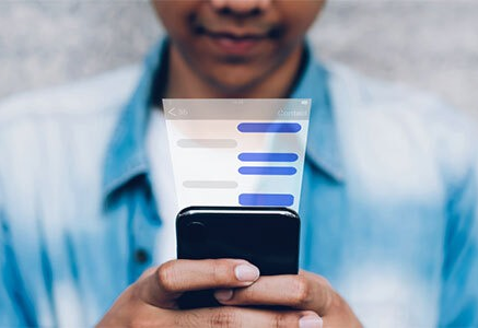 Man using cell phone with virtual chat overlay