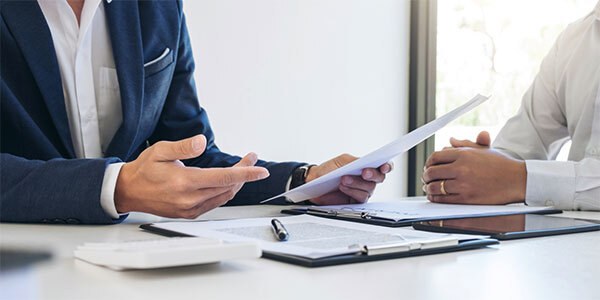 Hands holding document at desk