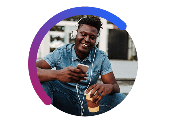 Man Looking at Smart Phone with Coffee and Headphones on