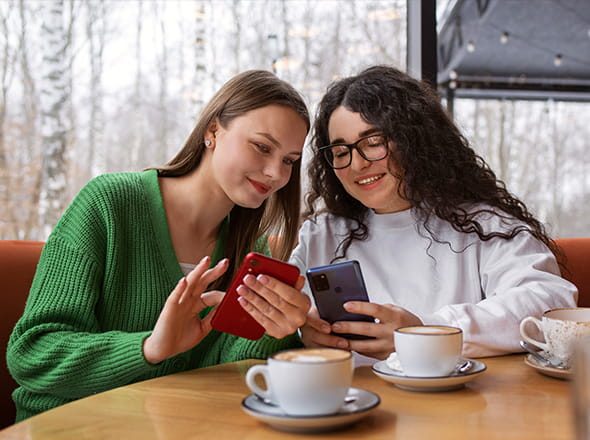 Two girls looking at phones