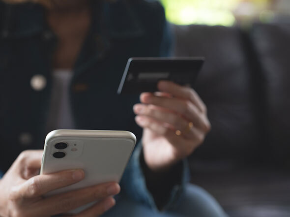 Woman in Black Denim Jacket Using Credit Card to Transfer Money on Cell Phone