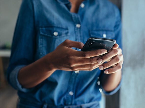 Closeup womans hands texting on cell phone