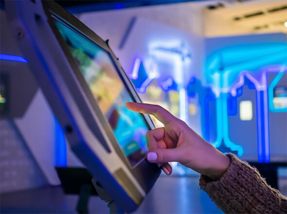 Hand pointing at kiosk