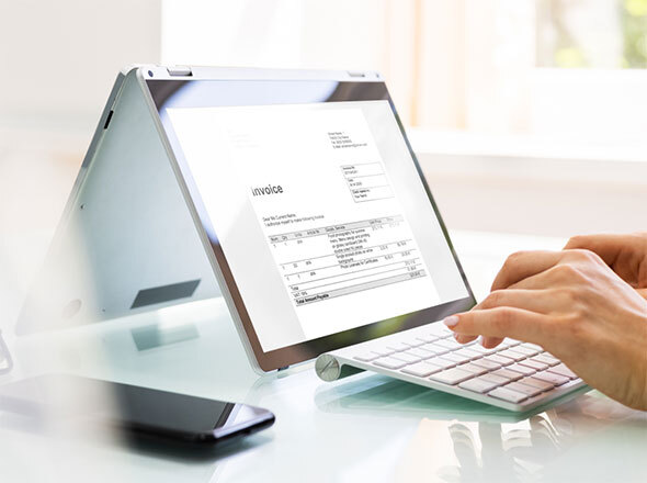 Hands typing on tablet keyboard