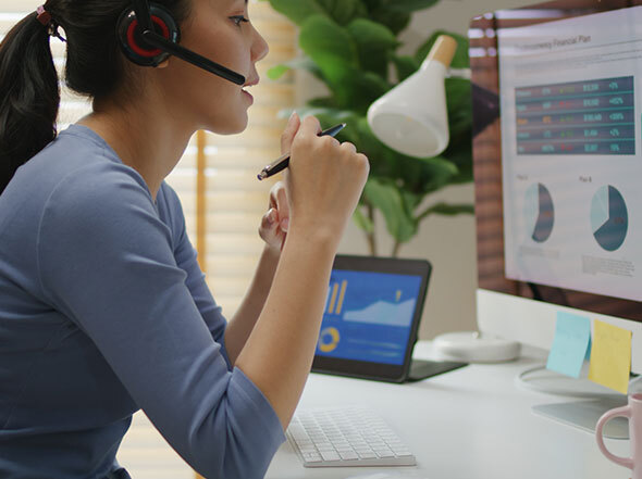 Woman with headset working on computer