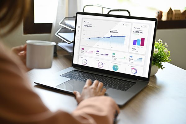 Woman looking at laptop min