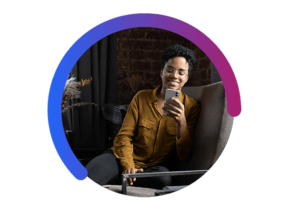 Woman on Couch Holding Cell Phone in Left Hand