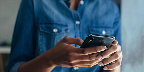 Closeup of Woman's Hands Texting on Cell Phone