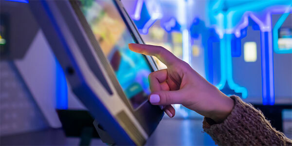 Manicured Finger Touching Screen on Payment Kiosk
