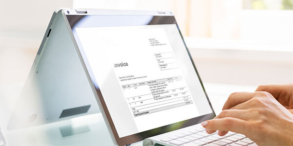 Manicured Hands Typing on Tablet Keyboard While Paying Invoice