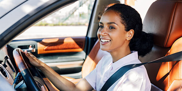 Woman Smiling While Driving Car
